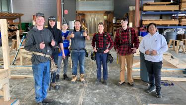 7 male students part of the skills competition pose for photo