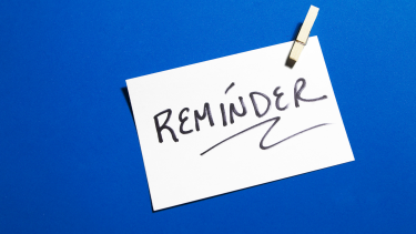 blue background with a white sign that says reminder