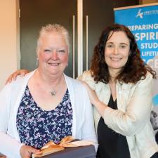 Female retiree poses with female principal