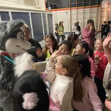 Group of students greeting the school husky mascot
