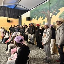 Highschool students watch a presentation together at their field trip to Gobind Sarvar